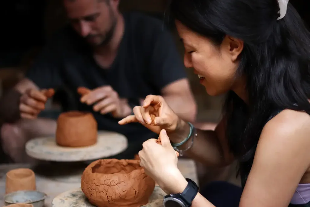 Two guests taking part in a hands-on pottery workshop in a village in Yunnan.