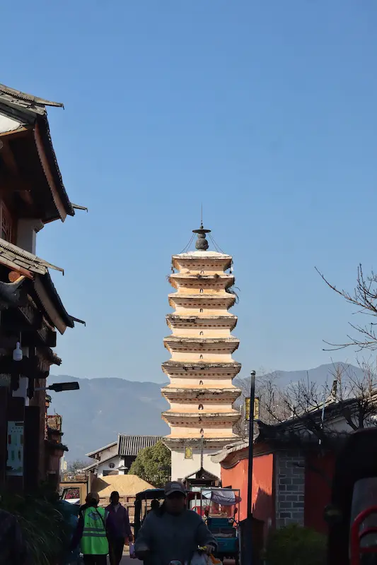 A multi-story white and yellow traditional Chinese pagoda in Weishan Old Town.