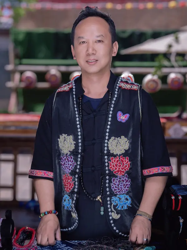 A portrait of one of Yunnan Eco Tours' collaborators, a Yi artisan specializing in traditional ethnic clothing.