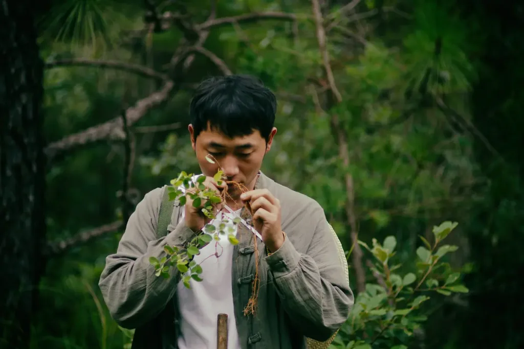 A traditional incense artisan in Jianshui smelling freshly foraged herbs.