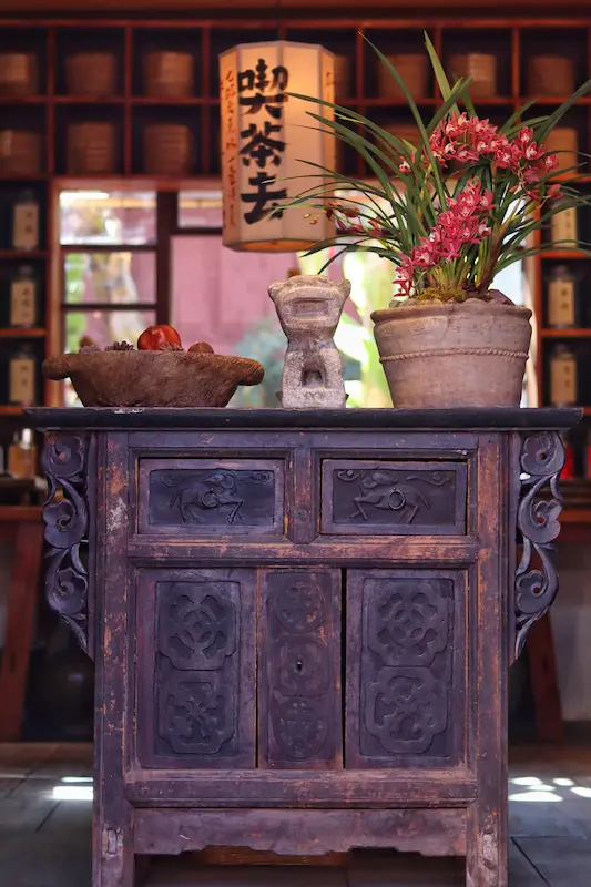 A traditional wooden cabinet displayed at the front of a tea shop.