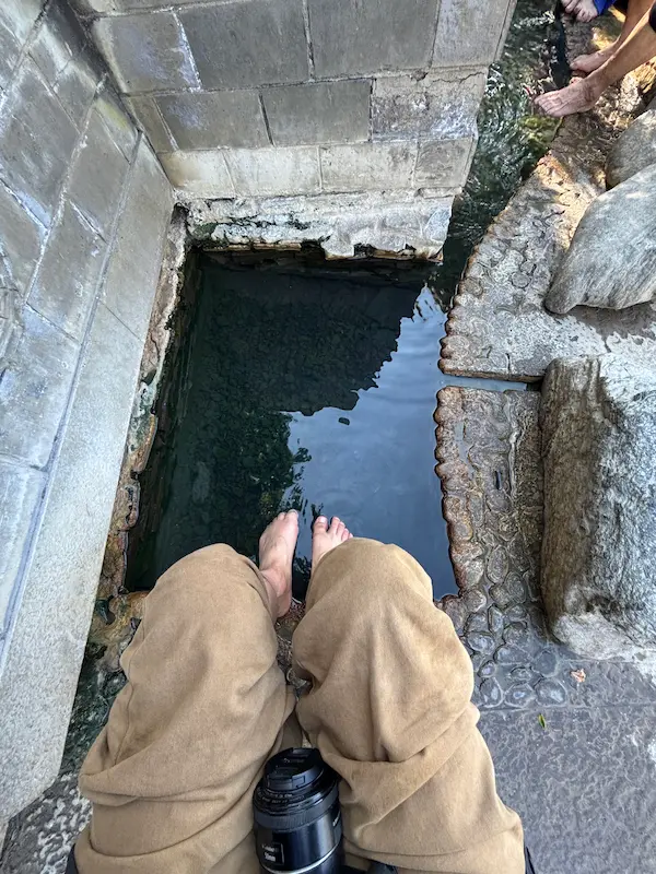 Leo soaking his feet in a natural hot spring in Dali.