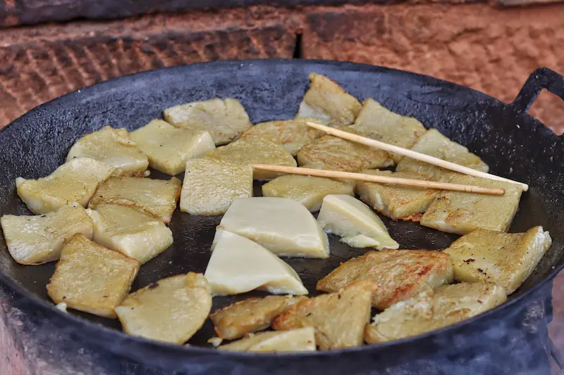 Lijiang chicken pea jelly being pan-fried.