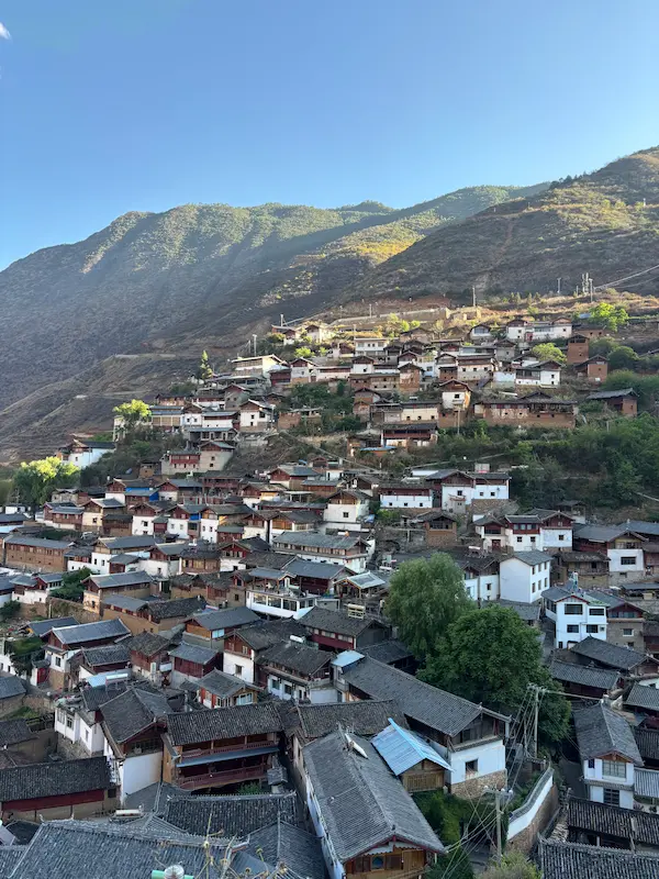 Naxi stone village with traditional rooftops along the Jinsha River near Lijiang, Yunnan