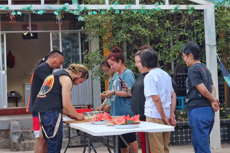 Singaporean guests enjoying a home-cooking experience with a Tibetan family in Lijiang.