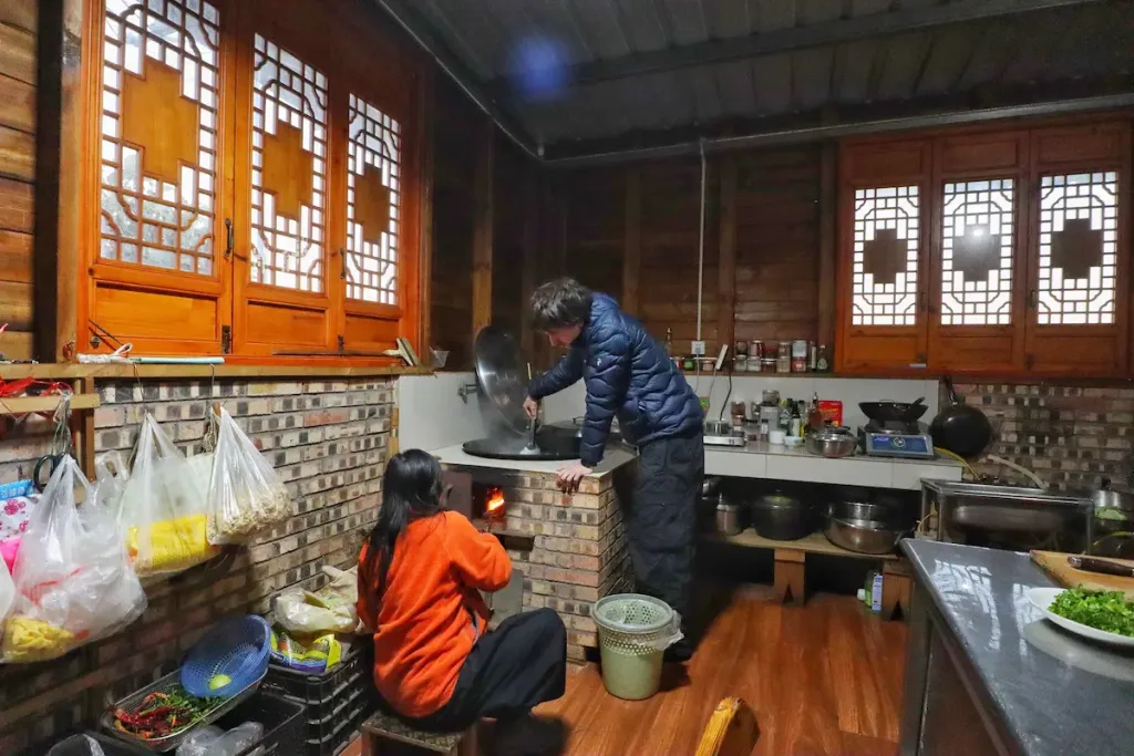 Two Australian guests cooking at a local family’s house in Yunnan.