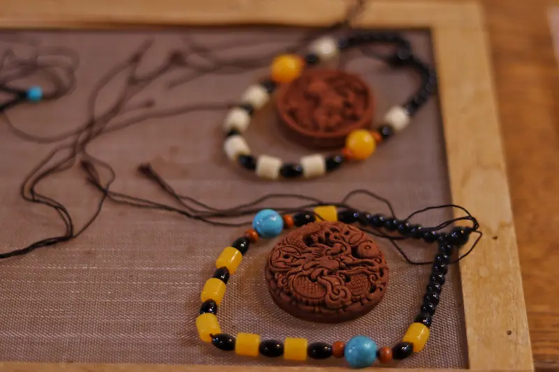 Two pendants made from blended incense ingredients.