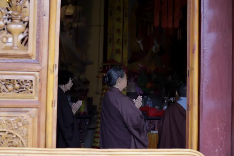 Worshippers praying inside a temple at Weibaoshan, Weishan, Yunnan.