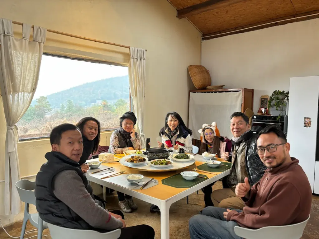 Yunnan Eco Tours founder Leo enjoying a meal with a group of guests from Asia.
