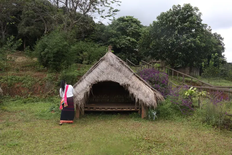 Traditional thatched hut at a Bulang village in Menghai County