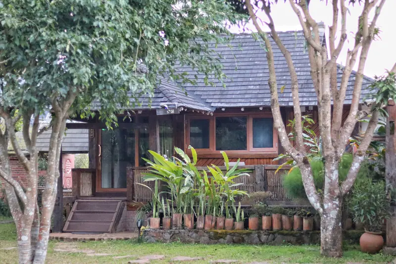Family-run eco-lodge set among trees in a Bulang village, Menghai