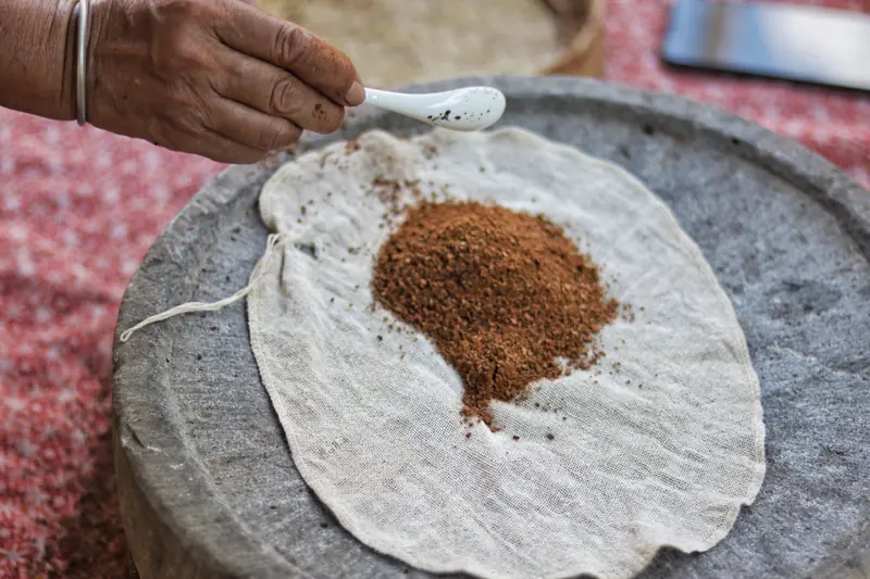 Freshly hand-ground coffee powder on a piece of cheesecloth, made the slow traditional Dai way