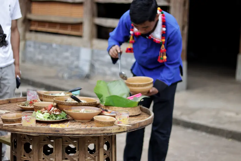 A De'ang family preparing a traditional home-cooked dinner in their village home