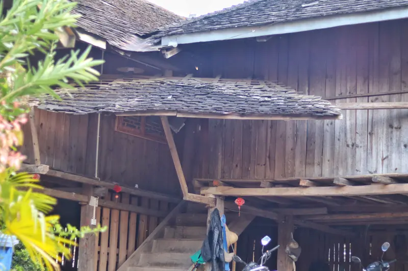 Traditional wooden stilt house with a shingled roof in a Lahu village, Pu'er