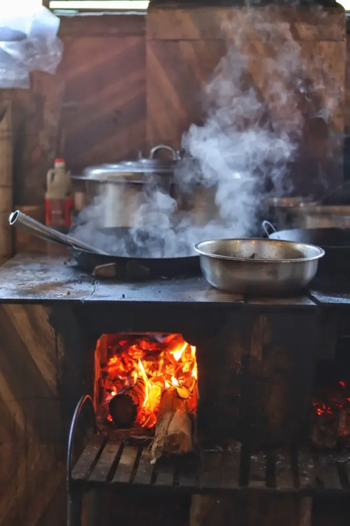 Street food cooking over a fire at a local market in Menglian