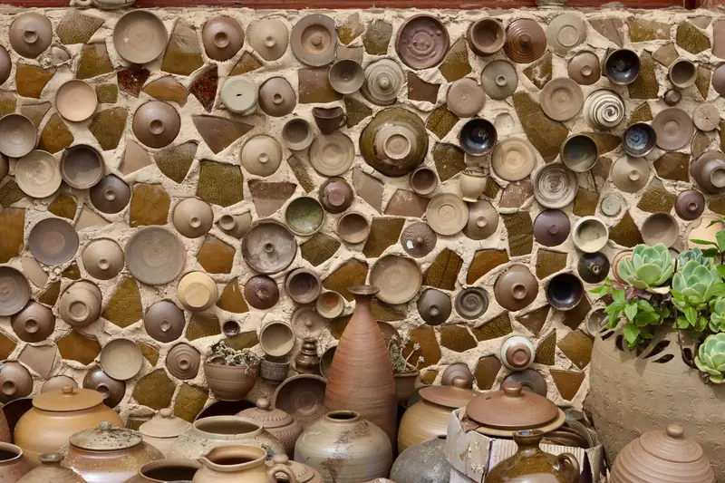 Rows of handmade clay pottery drying at a village workshop near Ning'er