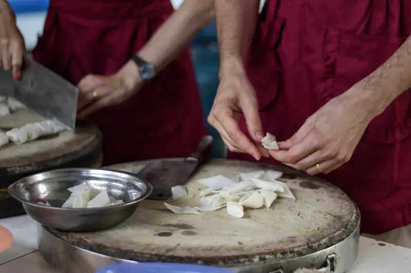 Preparing fresh ingredients by hand for the local Dajiujia dish in Tengchong