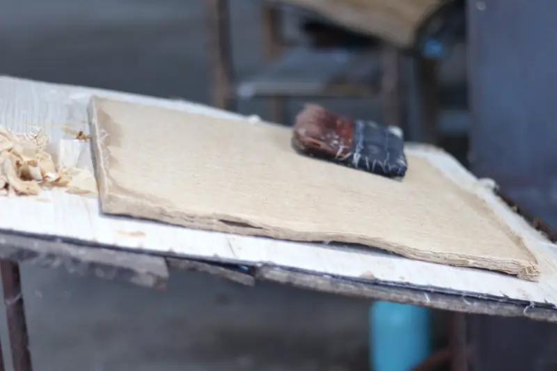 A sheet of handmade Xuan paper drying on a board in a Tengchong papermaking village