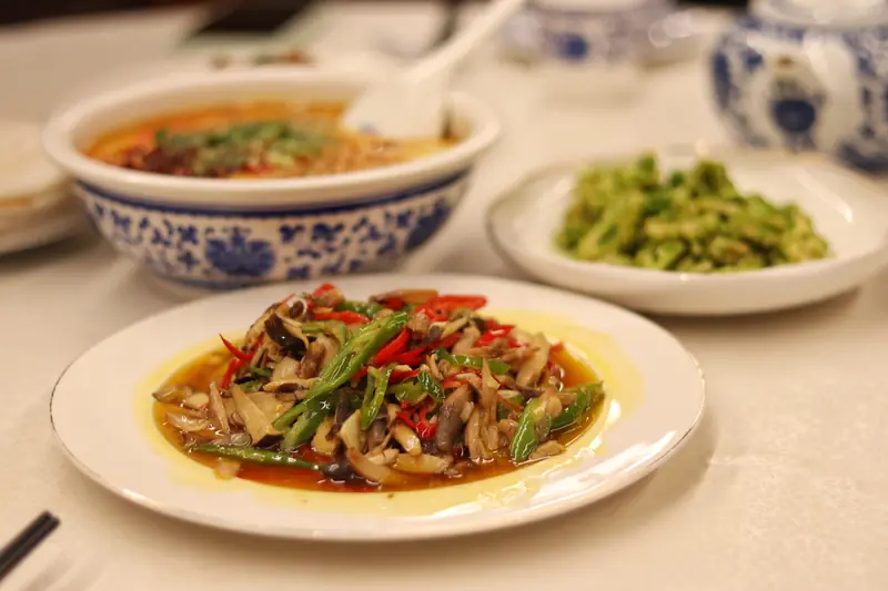 A spread of local seasonal dishes served for dinner at a Tengchong restaurant