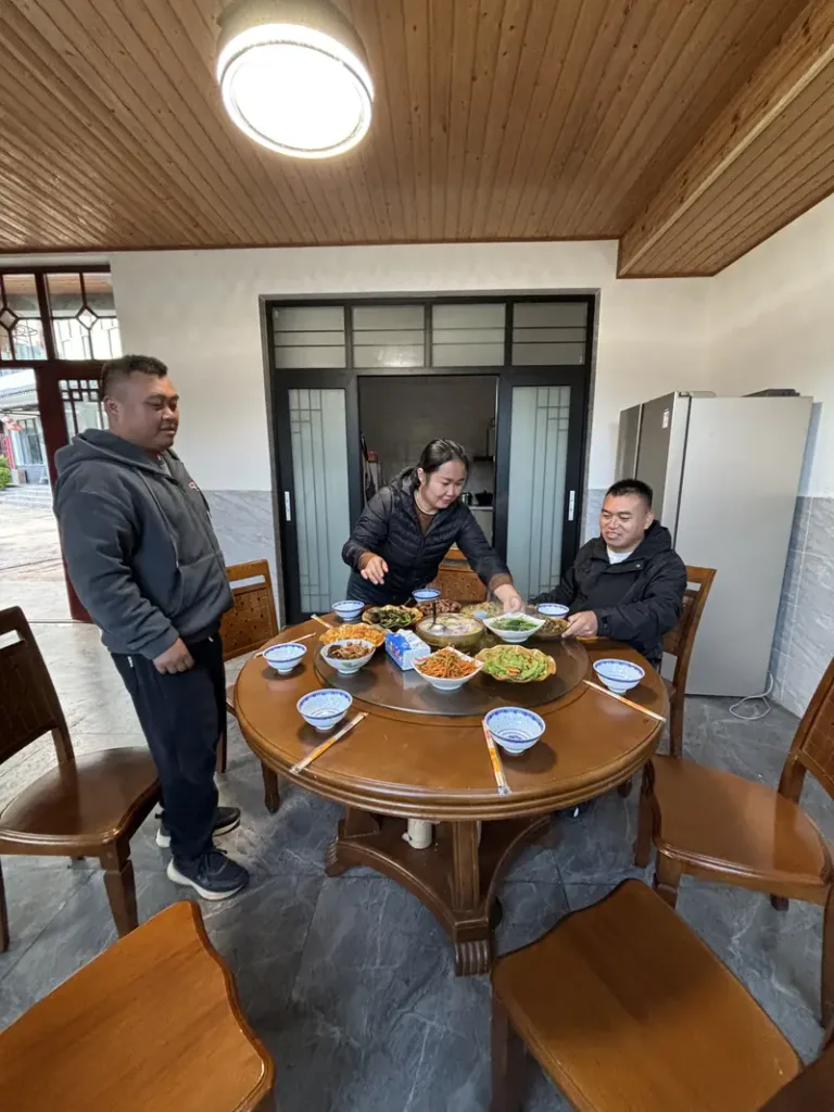 Sharing a home-cooked meal with a tea-farming family in Yiwu, Yunnan