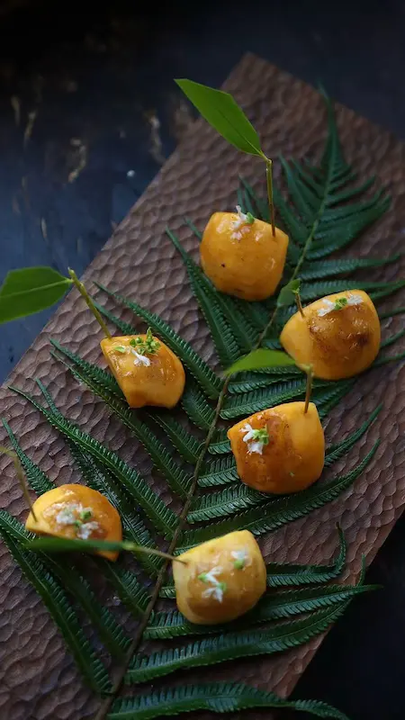 Bite-sized vegan course served on a fern leaf, Yunnan farm-to-table dinner