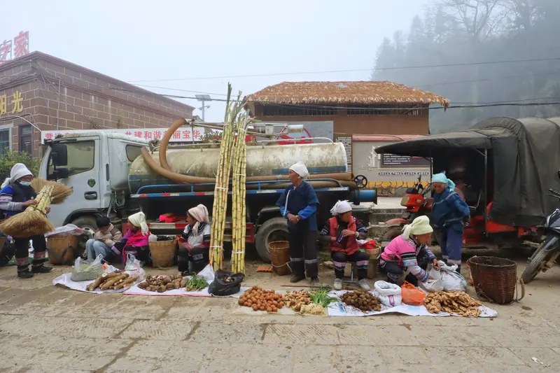 Sugarcane and fresh produce for sale at a Hani market.