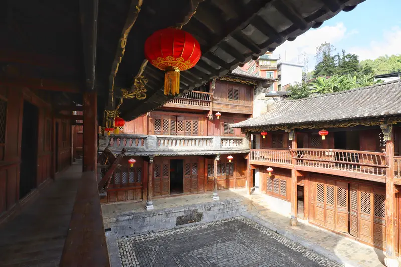 A red lantern hangs in a courtyard of the ancient Pu'er Tea Horse Road town.