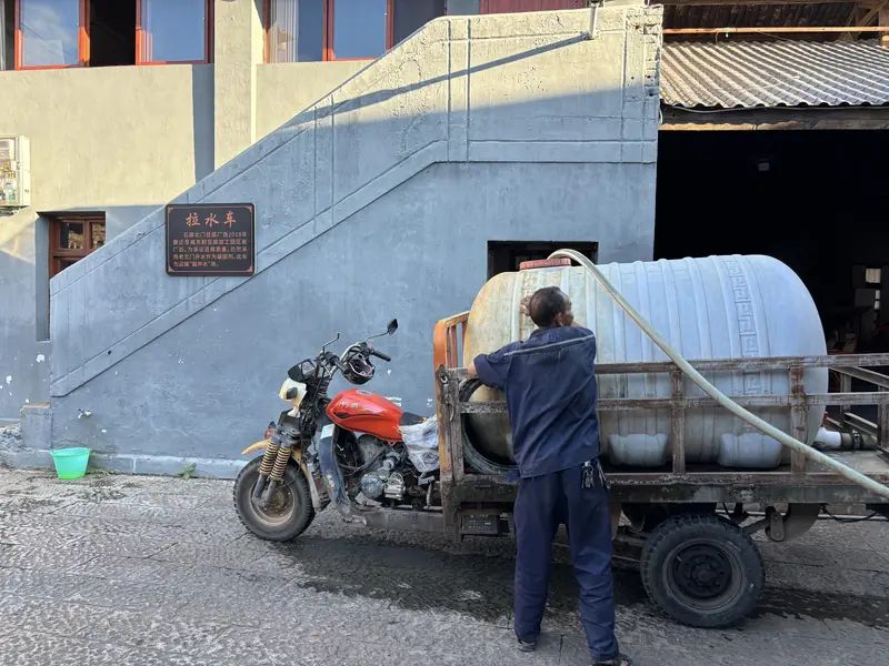 A cart collects water in Shiping, drawn from the town's historic wells prized for tofu-making.