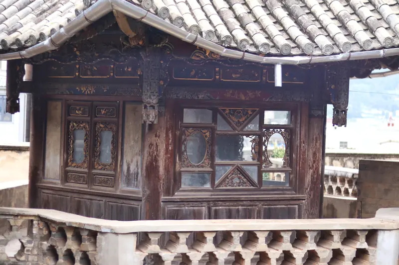 Carved wooden facade of a century-old courtyard house in Tonghai.
