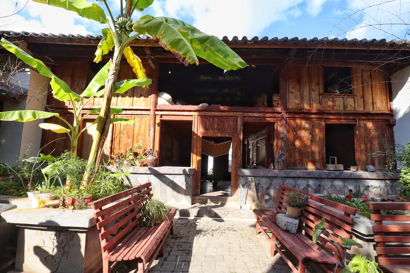 Wooden exterior of a century-old Tonghai courtyard house now used as a cafe.