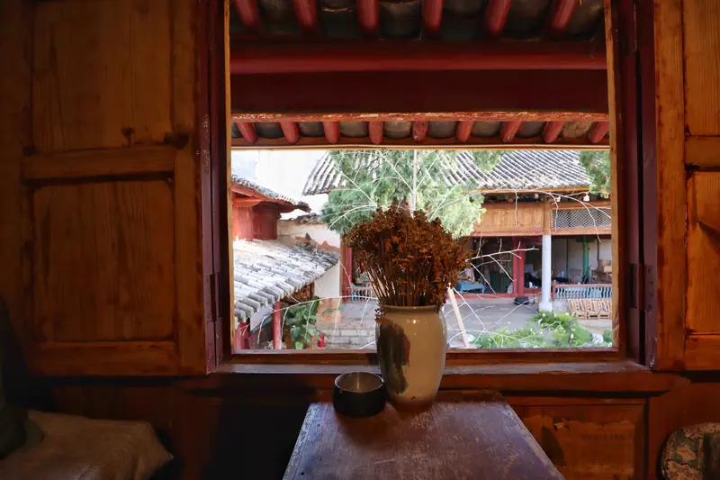 View through a wooden window of a courtyard house in Tonghai.