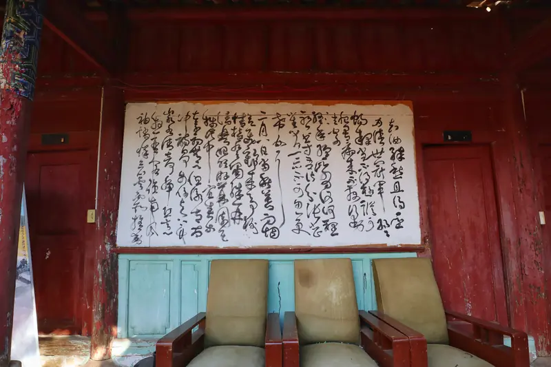 Chinese calligraphy scroll hangs inside a century-old courtyard teahouse in Tonghai.