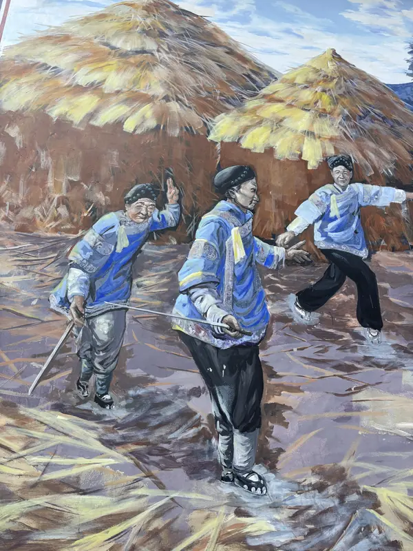 A colorful mural depicting bound feet women decorates a wall in the Tonghai village.