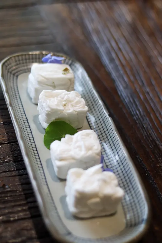 Tray of white folded parcels, Yunnan fine dining course
