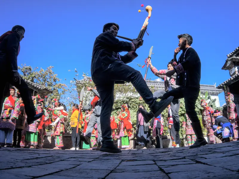 Yi minority dancers performing for visitors in Yunnan