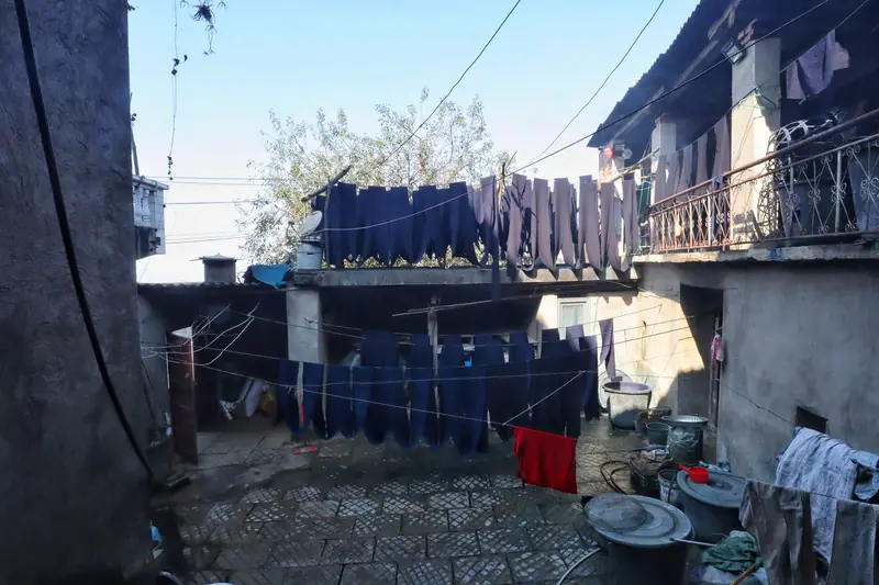 Indigo-dyed cloth dries in the courtyard of a Yi village home.