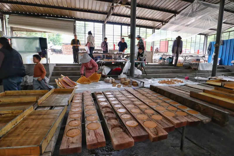 Freshly made cane sugar cools in wooden molds at a traditional workshop.