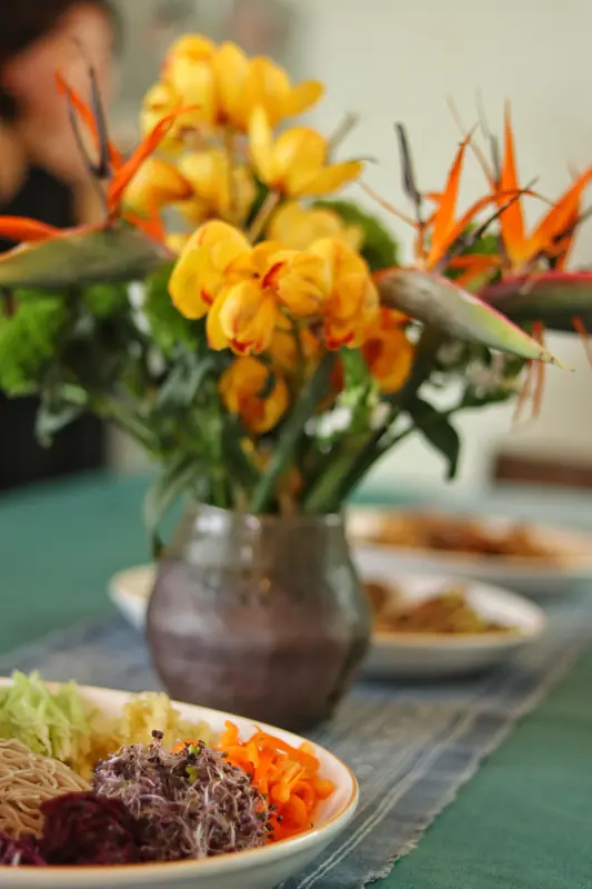 Finished dishes and flowers on the table after a Yunnan cooking workshop
