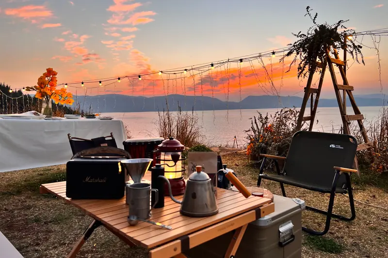 Outdoor dinner table set up at sunset on an organic farm in Yunnan