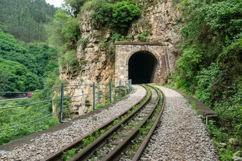Tracks lead into a hand-carved tunnel on the Kunming–Yiliang stretch of the railway.