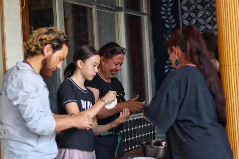 Guests making momos during a home-cooking experience with a Tibetan family in Yunnan